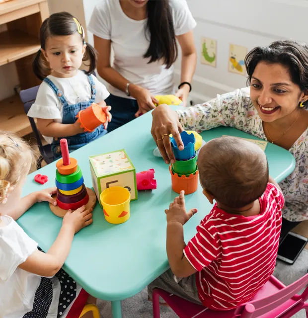daycare-programs-near-renton-prek-explorers Toddlers exploring toys and interacting in a nurturing childcare program near Renton
